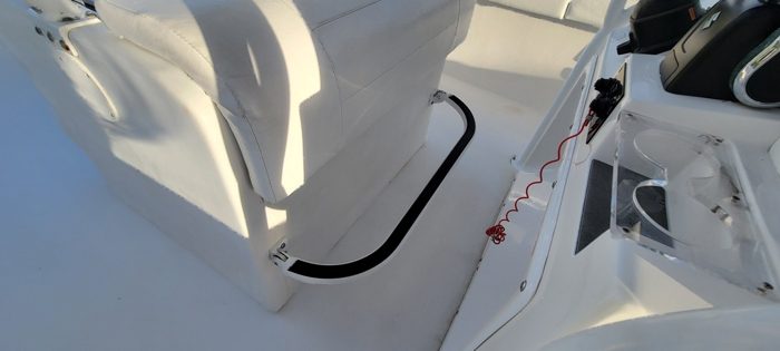 Folding footrest for the captain's bench
